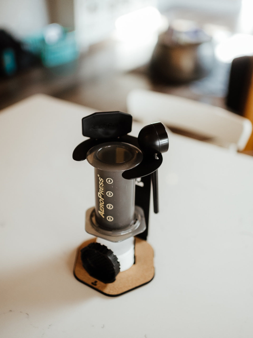 A AeroPress Brewer being held in the Proper by Design AeroPress Organizer.
