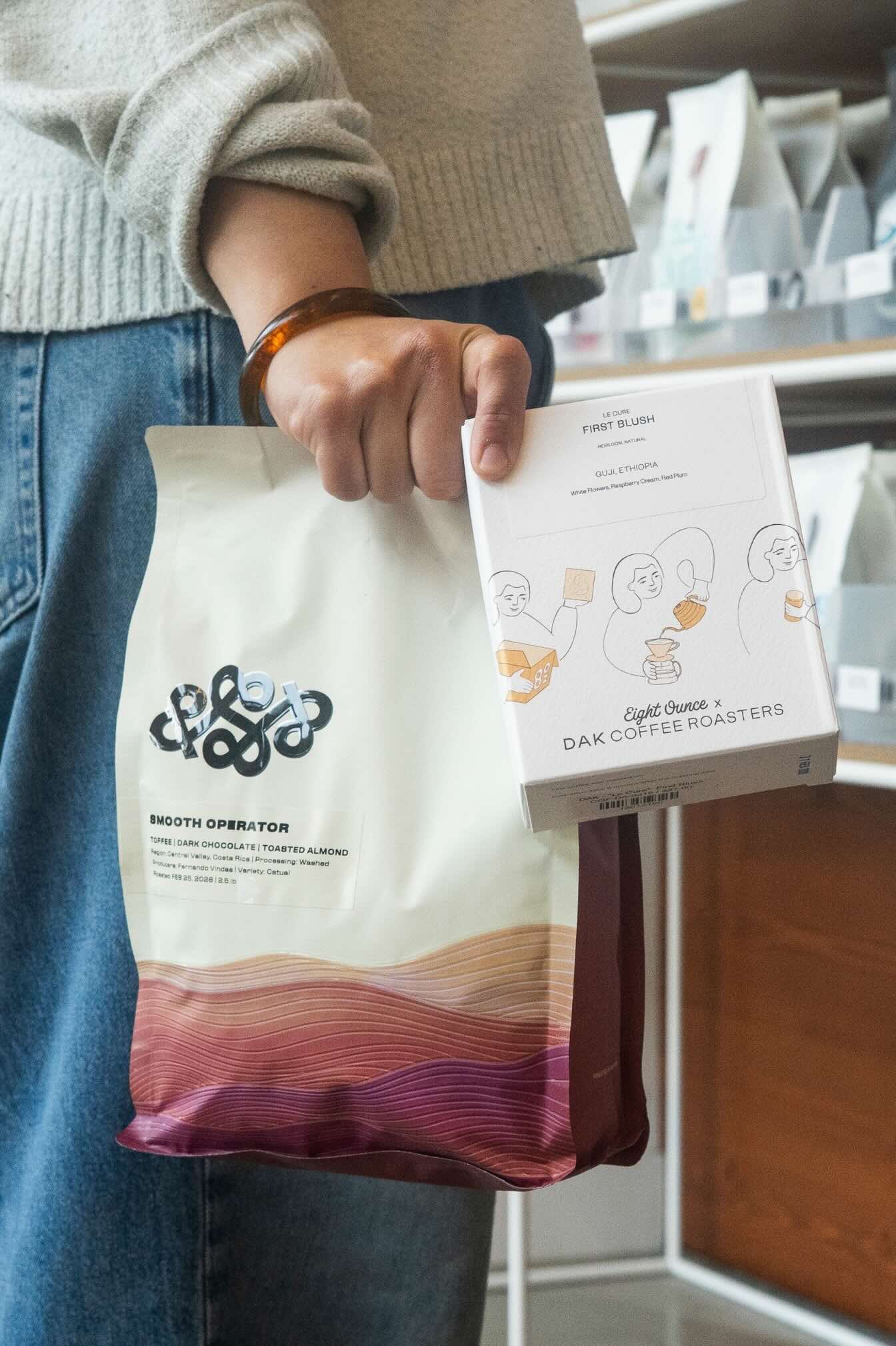 Person holding coffee bags.