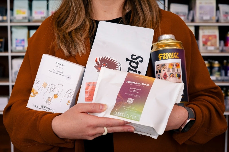 Person holding bags of coffee